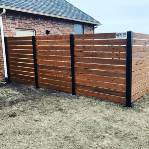 Custom horizontal cedar stockade fence with metal posts by Fence OKC.