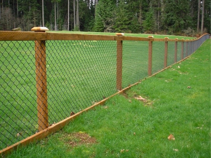 Chain link and wood combined to make a beautiful fence.