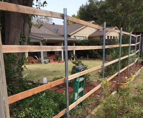 Fence OKC installing a new residential cedar fence in an Oklahoma backyard.