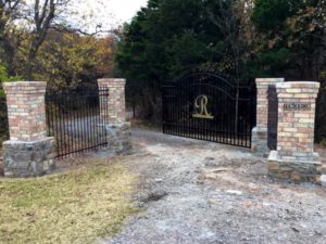 Complete driveway entrance with automated gate installed by Fence OKC.