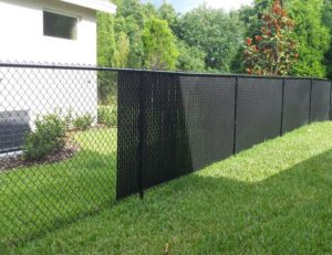 Chain link privacy slats installed on a chain link fence.