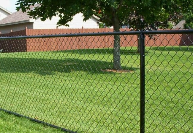 Black vinyl chain link fence installed in Oklahoma.