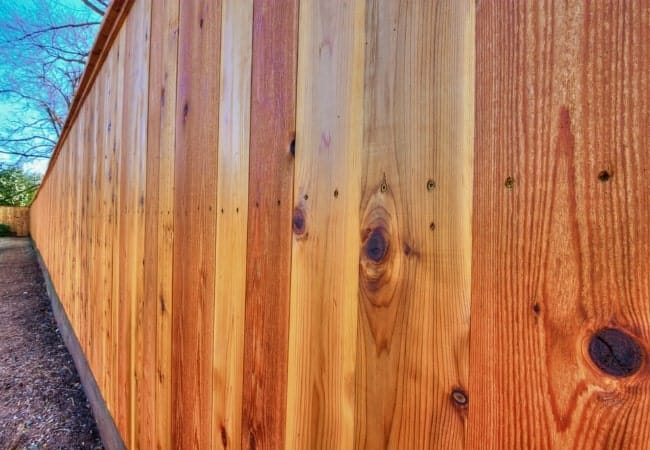 Cedar fence installed in OKC with runner and cap and trim.