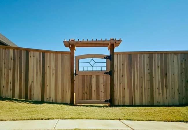 Cedar fence installed with a custom walkthrough gate by Fence OKC.