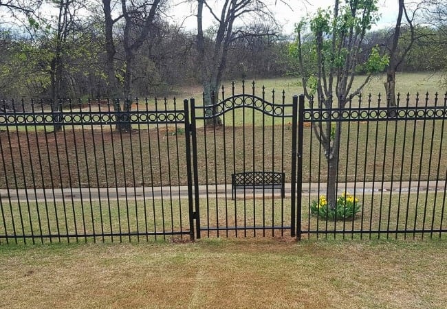 Residential ornamental iron fence installation in Oklahoma by Fence OKC.