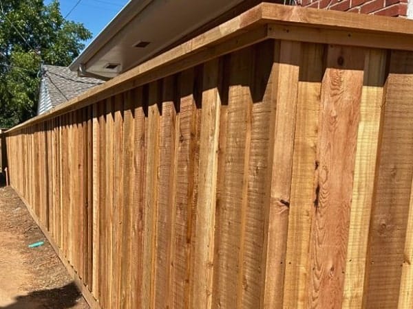 Board on board with cap and trim residential fencing by Fence OKC.