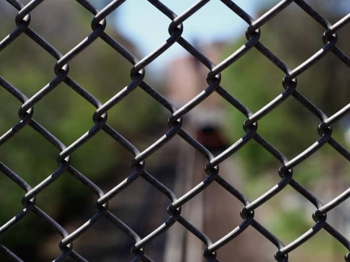 Chain link fence installation in Oklahoma landscape.