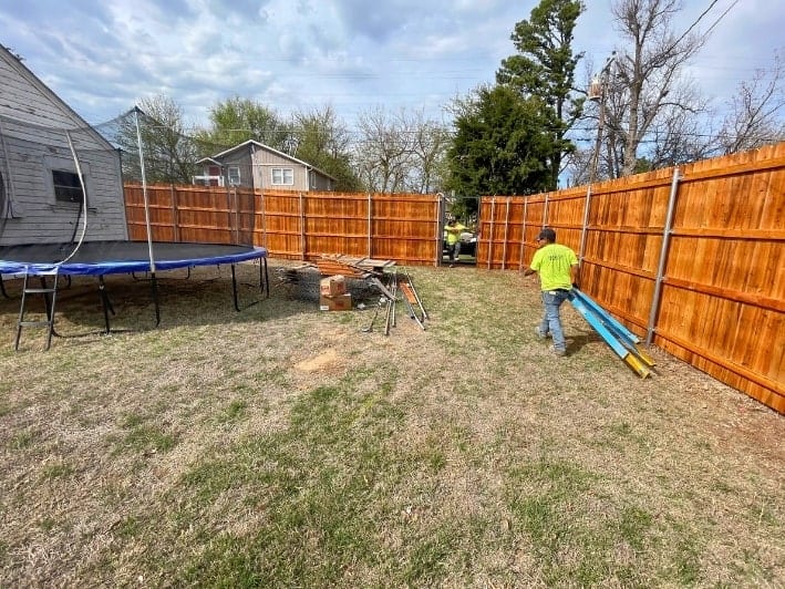 A professional team from Fence OKC installing a fence in Blanchard, Oklahoma, for a residential property.