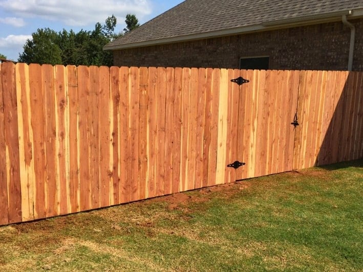 Cedar fences enhancing Oklahoma properties' charm and durability.