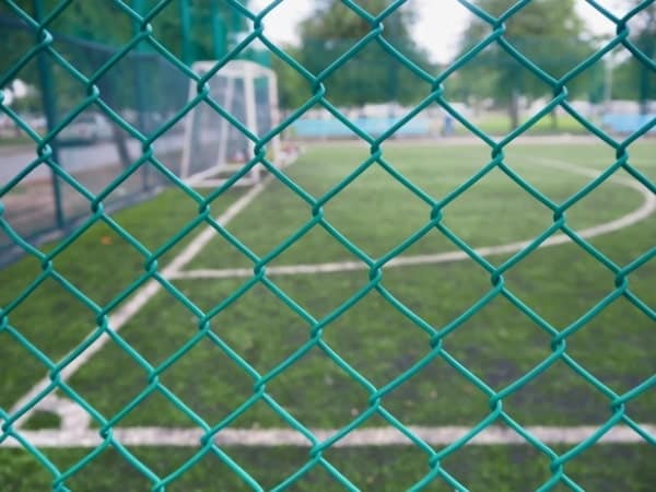 Green vinyl chain link installed around a soccer field.